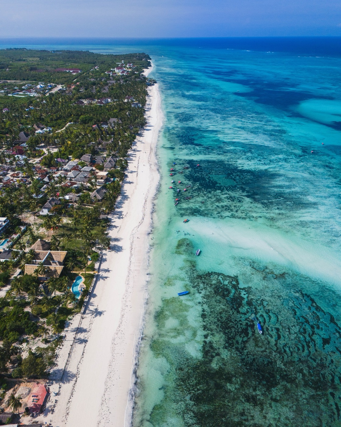 White beach and turquoise reef on the Zanzibar coast, seen from above