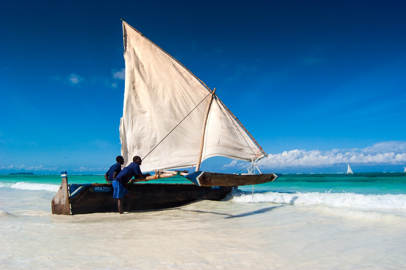 A traditional Zanzibar dhow on a white-sand beach